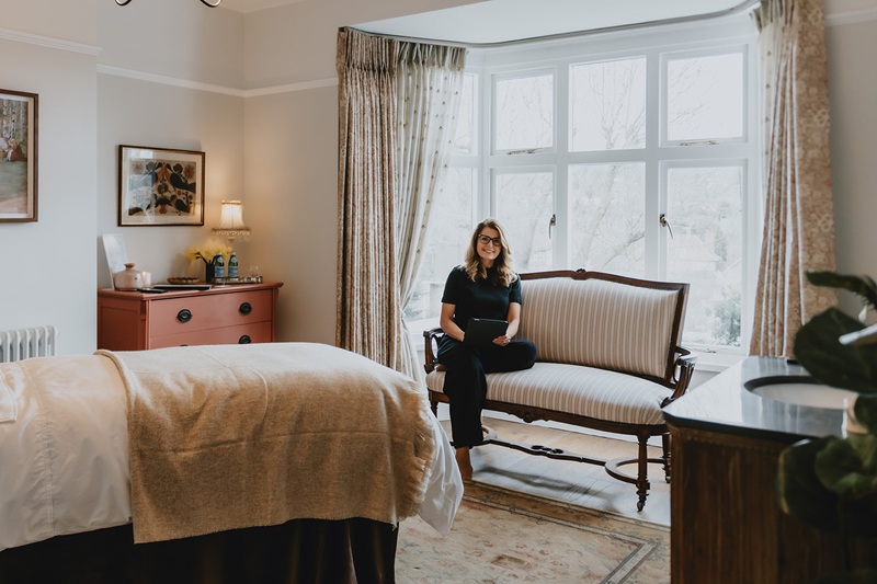 Jane sitting in her treatment room
